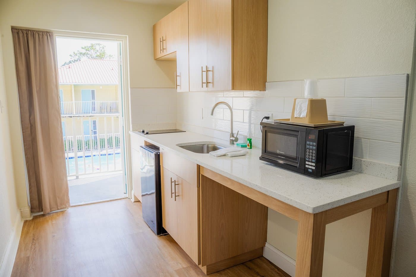 In-room kitchenette overlooking the saltwater pool